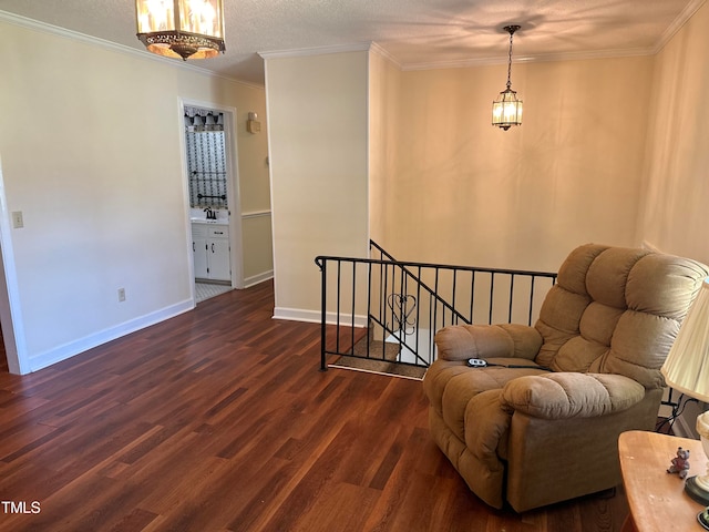 sitting room featuring crown molding, dark hardwood / wood-style flooring, sink, and a textured ceiling