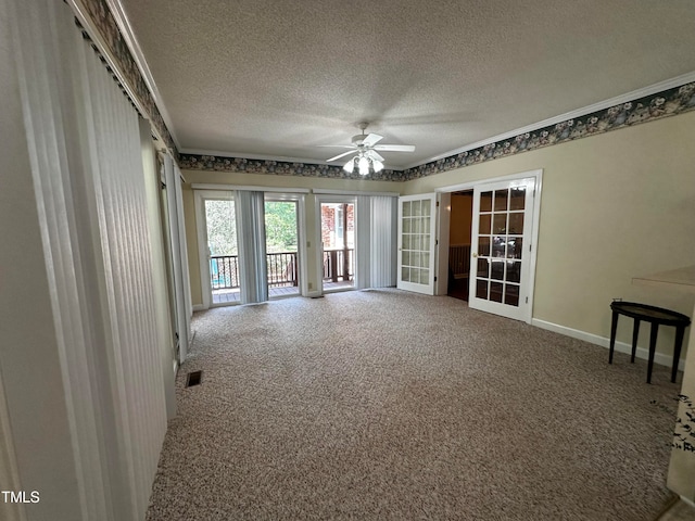 interior space featuring ceiling fan, ornamental molding, a textured ceiling, and carpet flooring