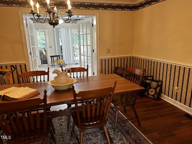 dining space featuring a notable chandelier and hardwood / wood-style flooring