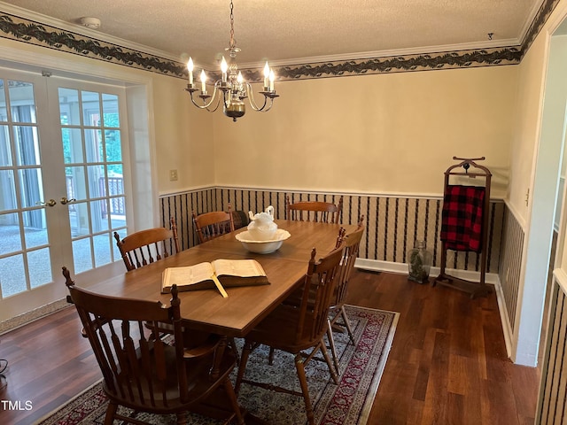 dining room with crown molding, dark hardwood / wood-style flooring, a textured ceiling, and french doors