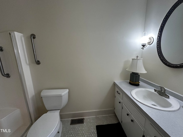 bathroom featuring tile patterned floors, vanity, and toilet