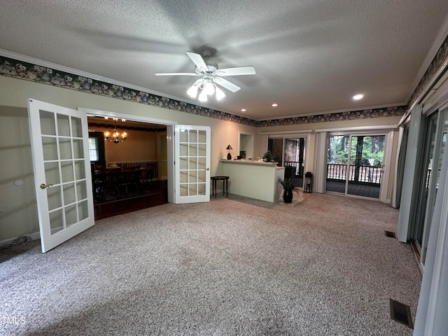 unfurnished living room with carpet floors, french doors, and a textured ceiling