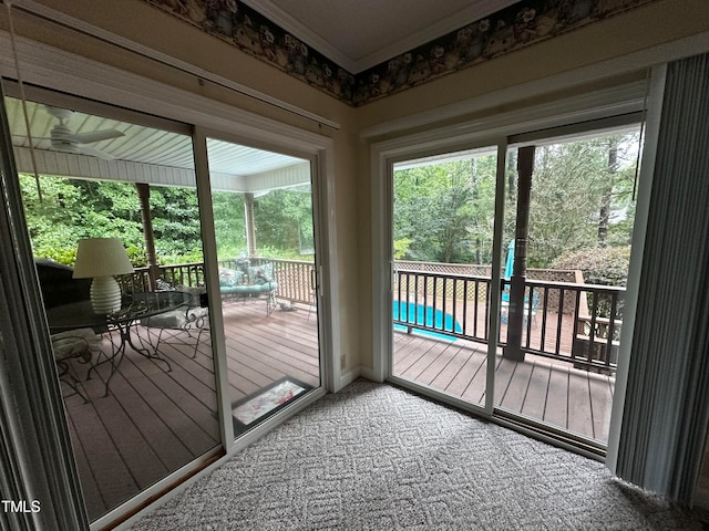 entryway featuring crown molding and carpet