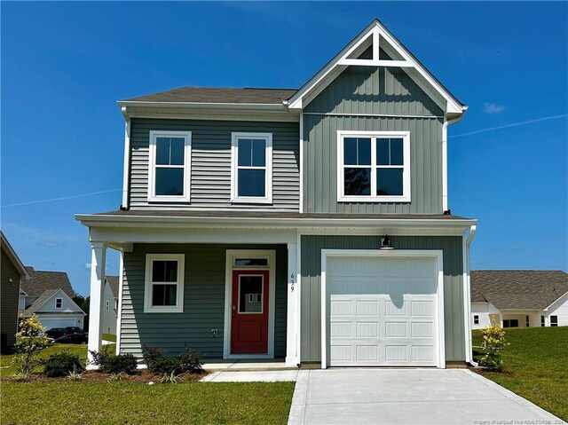 view of front facade with a garage and a front lawn