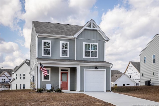 view of front of home with a garage and central AC unit