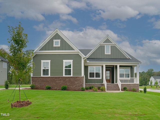 16 Autumn Breeze Ct, Angier, NC 27501 - craftsman house featuring board and batten siding, a front lawn, a porch, and brick siding