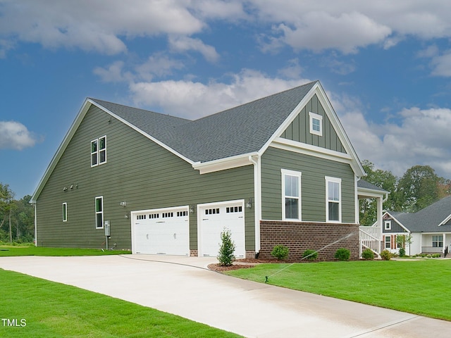 16 Autumn Breeze Ct, Angier, NC 27501 - view of front of house with board and batten siding, concrete driveway, a front lawn, brick siding, and a garage