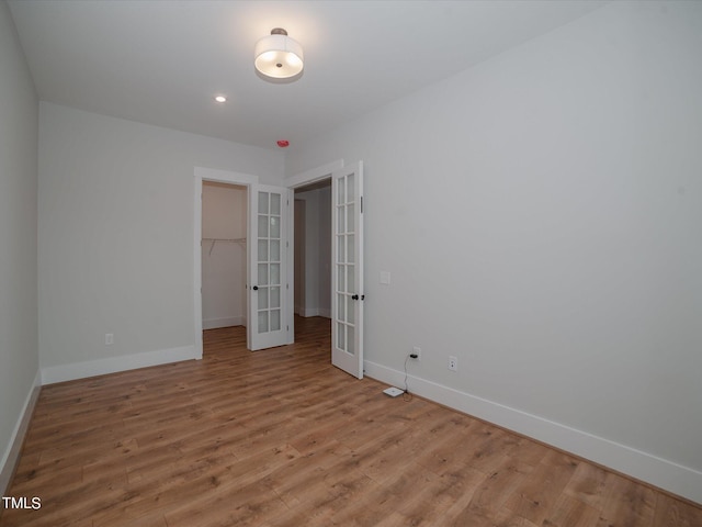 16 Autumn Breeze Ct, Angier, NC 27501 - unfurnished bedroom with french doors, baseboards, and wood finished floors