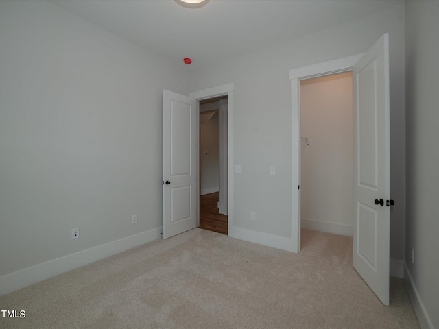 16 Autumn Breeze Ct, Angier, NC 27501 - unfurnished bedroom with carpet flooring, baseboards, and a spacious closet