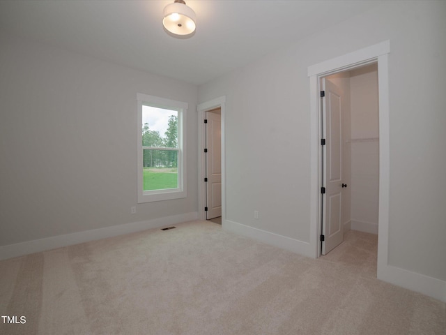 16 Autumn Breeze Ct, Angier, NC 27501 - unfurnished bedroom with carpet, a walk in closet, and baseboards