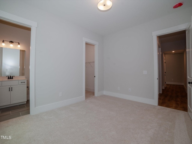 16 Autumn Breeze Ct, Angier, NC 27501 - unfurnished bedroom with carpet floors, a walk in closet, connected bathroom, baseboards, and a closet