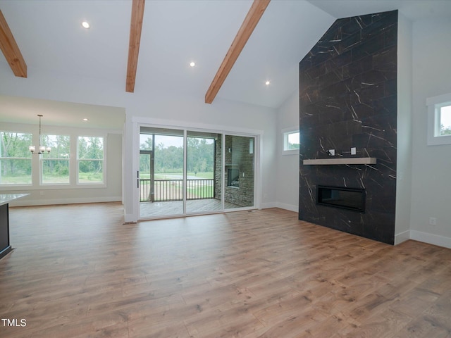 16 Autumn Breeze Ct, Angier, NC 27501 - unfurnished living room featuring plenty of natural light, beamed ceiling, baseboards, wood finished floors, and recessed lighting