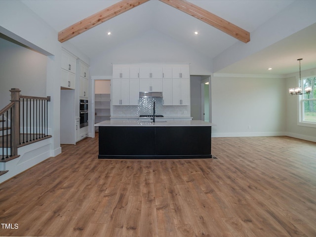 16 Autumn Breeze Ct, Angier, NC 27501 - kitchen featuring light countertops, a chandelier, an island with sink, white cabinetry, and beam ceiling