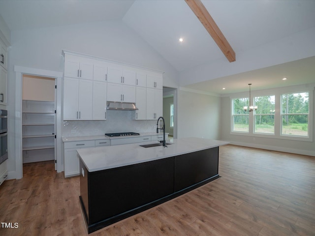 16 Autumn Breeze Ct, Angier, NC 27501 - kitchen with a sink, a chandelier, high vaulted ceiling, black cooktop, and light countertops