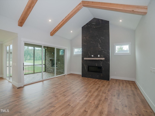 16 Autumn Breeze Ct, Angier, NC 27501 - unfurnished living room featuring a premium fireplace, beam ceiling, wood finished floors, high vaulted ceiling, and baseboards
