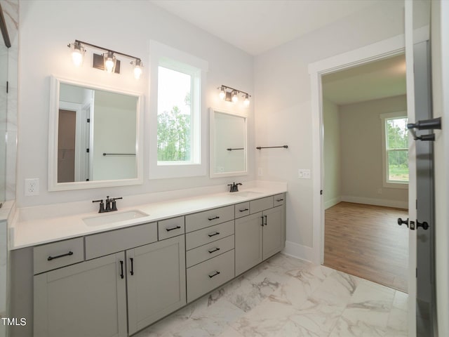 16 Autumn Breeze Ct, Angier, NC 27501 - bathroom featuring double vanity, marble look tiles, and baseboards