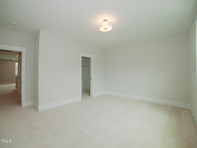 16 Autumn Breeze Ct, Angier, NC 27501 - unfurnished bedroom with light colored carpet, a walk in closet, and a closet