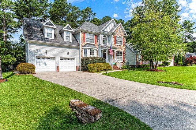 view of front of property with a garage and a front yard