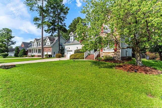 view of front of house with a garage and a front lawn