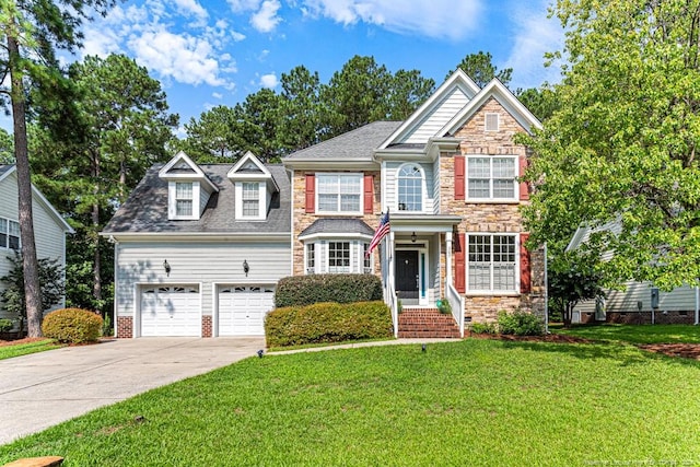 view of front of property with a garage and a front lawn