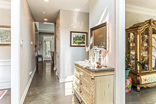 hallway featuring ornamental molding and dark hardwood / wood-style floors