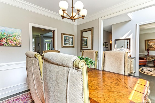 dining space featuring ornamental molding and a notable chandelier