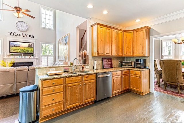 kitchen featuring dark hardwood / wood-style floors, tasteful backsplash, dishwasher, sink, and light stone counters