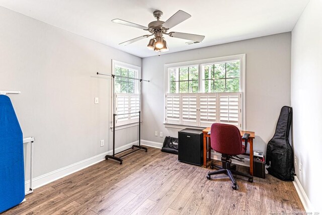 office space with ceiling fan and light wood-type flooring