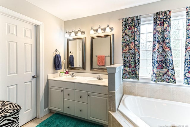 bathroom featuring vanity, tiled tub, and tile patterned floors