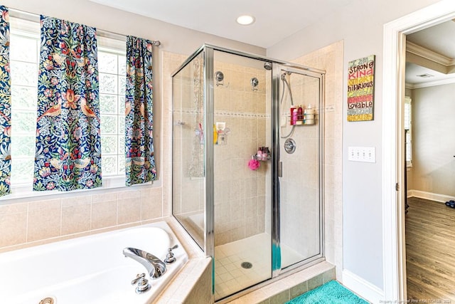 bathroom featuring crown molding, separate shower and tub, and wood-type flooring