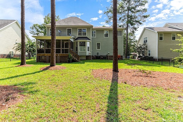 rear view of property with a sunroom and a lawn