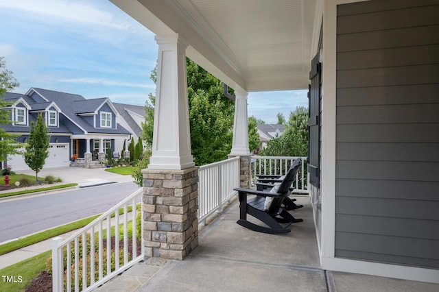 view of patio featuring a garage and a porch