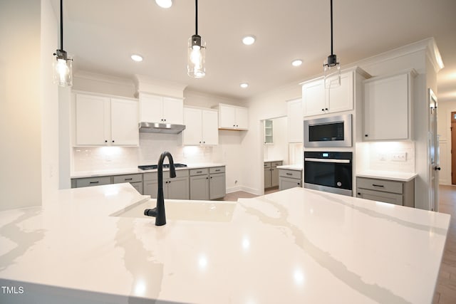 kitchen featuring hardwood / wood-style flooring, decorative light fixtures, and backsplash