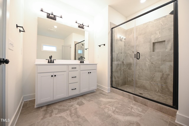 bathroom with vanity and a shower with shower door