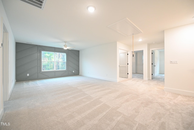 carpeted spare room with ceiling fan