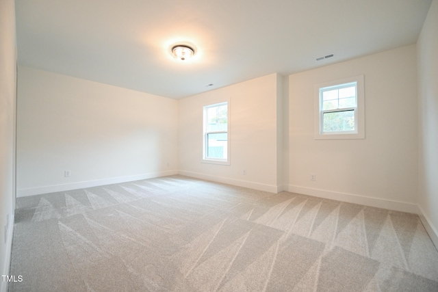 spare room with light carpet