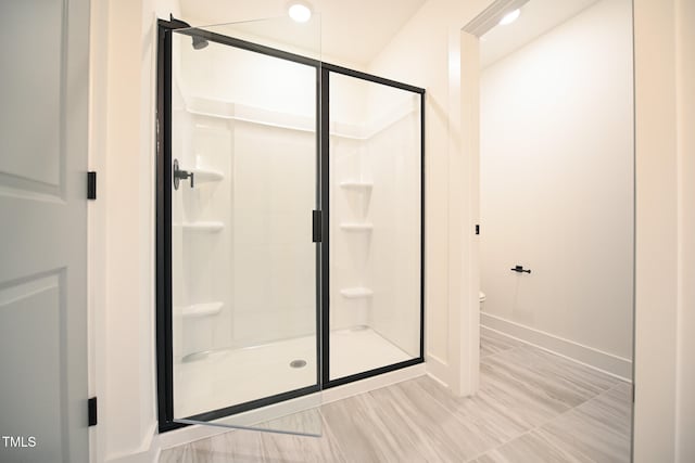 bathroom with toilet and walk in shower