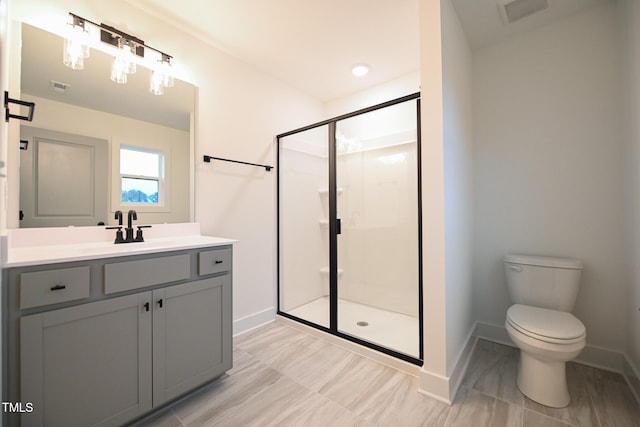 bathroom with vanity, toilet, and walk in shower