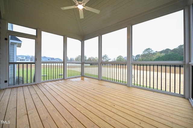 unfurnished sunroom featuring ceiling fan, a water view, and lofted ceiling