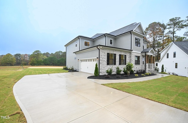 view of front of property with a garage and a front yard