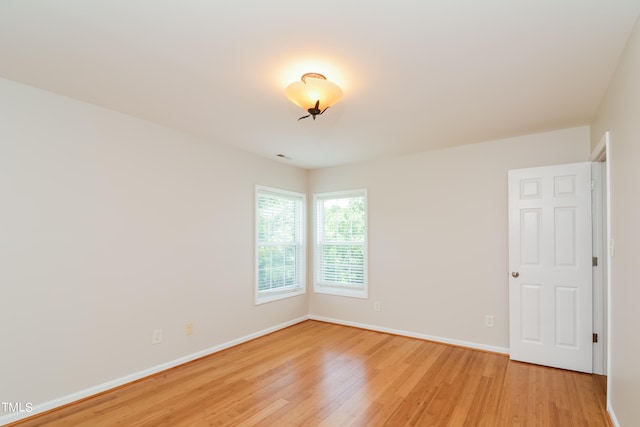 spare room with light hardwood / wood-style flooring