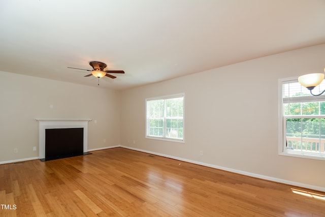 unfurnished living room with light hardwood / wood-style floors and ceiling fan