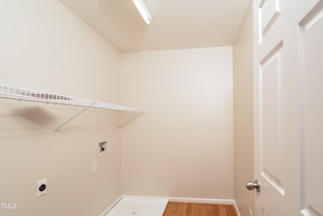 laundry room with electric dryer hookup, hardwood / wood-style floors, and washer hookup