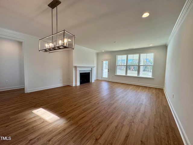 unfurnished living room with ornamental molding and dark wood-type flooring