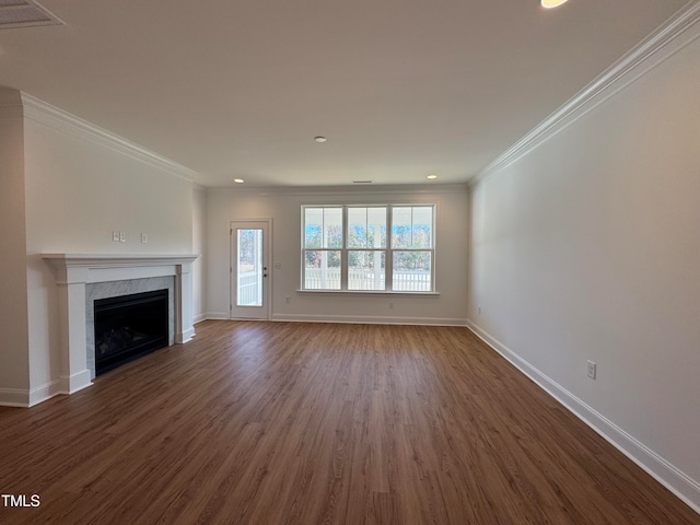 unfurnished living room with a tiled fireplace, crown molding, and dark hardwood / wood-style floors