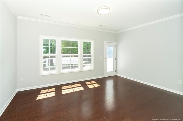 empty room with a healthy amount of sunlight, crown molding, and hardwood / wood-style floors