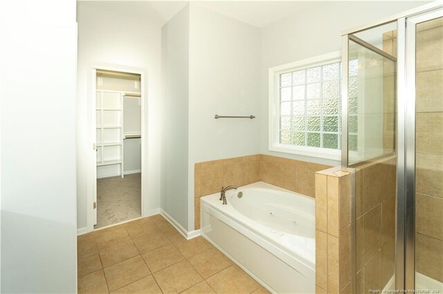 bathroom with tile patterned flooring and independent shower and bath