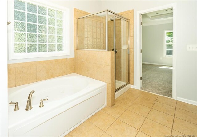 bathroom featuring tile patterned floors and separate shower and tub