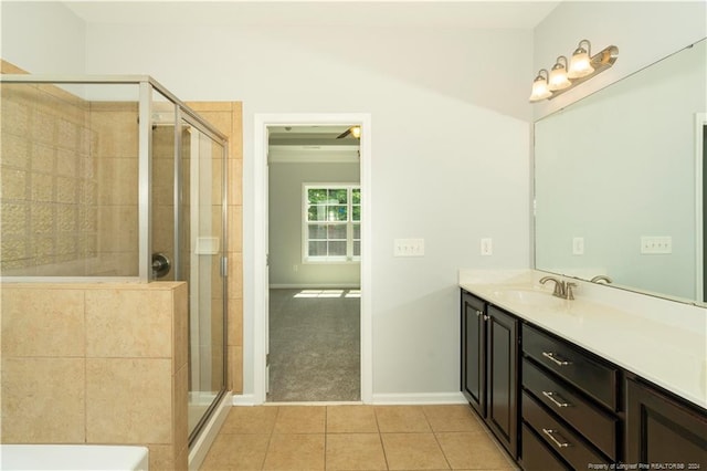 bathroom featuring tile patterned flooring, a shower with door, and vanity