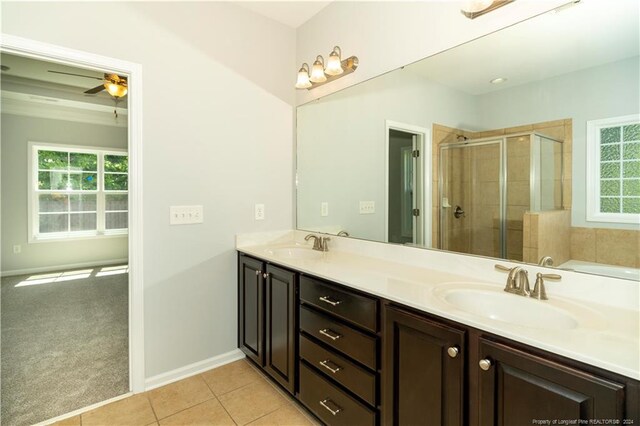 bathroom featuring dual vanity, tile patterned floors, an enclosed shower, and ceiling fan